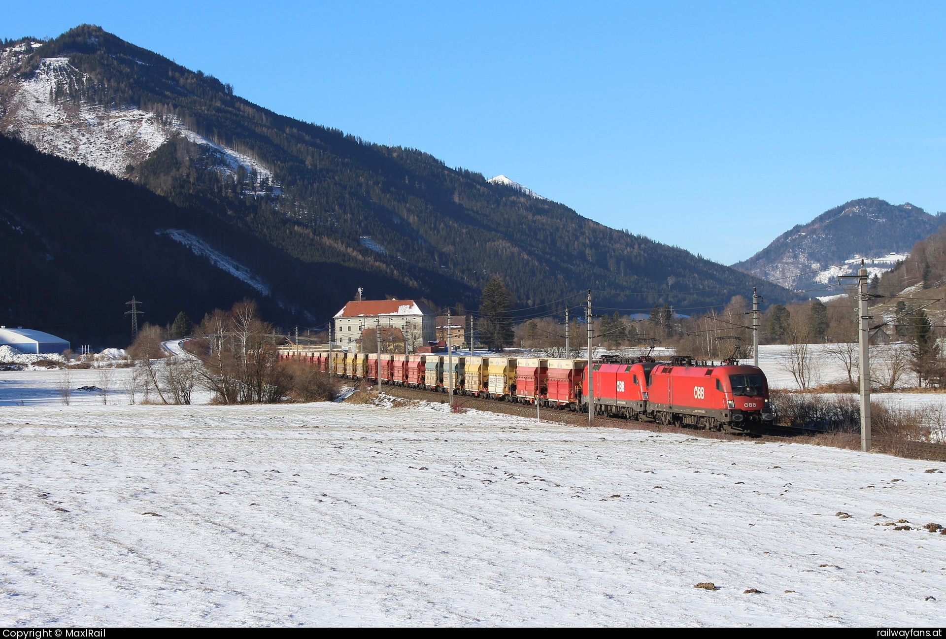 ÖBB 1116 058 in Mautern in Steiermark - Mit einem beladenen Erzzug von Eisenerz nach Leoben Donawitz rollen am 27.12.2024 die 1116 058 und die 1016 021 den Schoberpass talwärts hier kurz vor Mautern mit dem Schliss Ehrenau aus dem 13. Jahrhundert.  Schoberpass Railwayfans